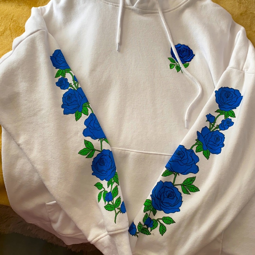 All white Zumiez hoodie with blue roses